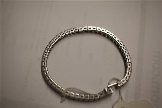 A platinum, iridium and diamond line bracelet, 17.8cm.